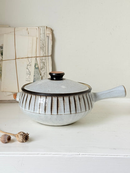 Denby Studio large two handled lidded casserole in grey and rust photographed on a white surface