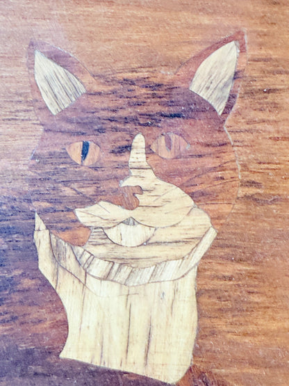 Vintage wooden tray with cat marquetry inlay, photographed on a white surface