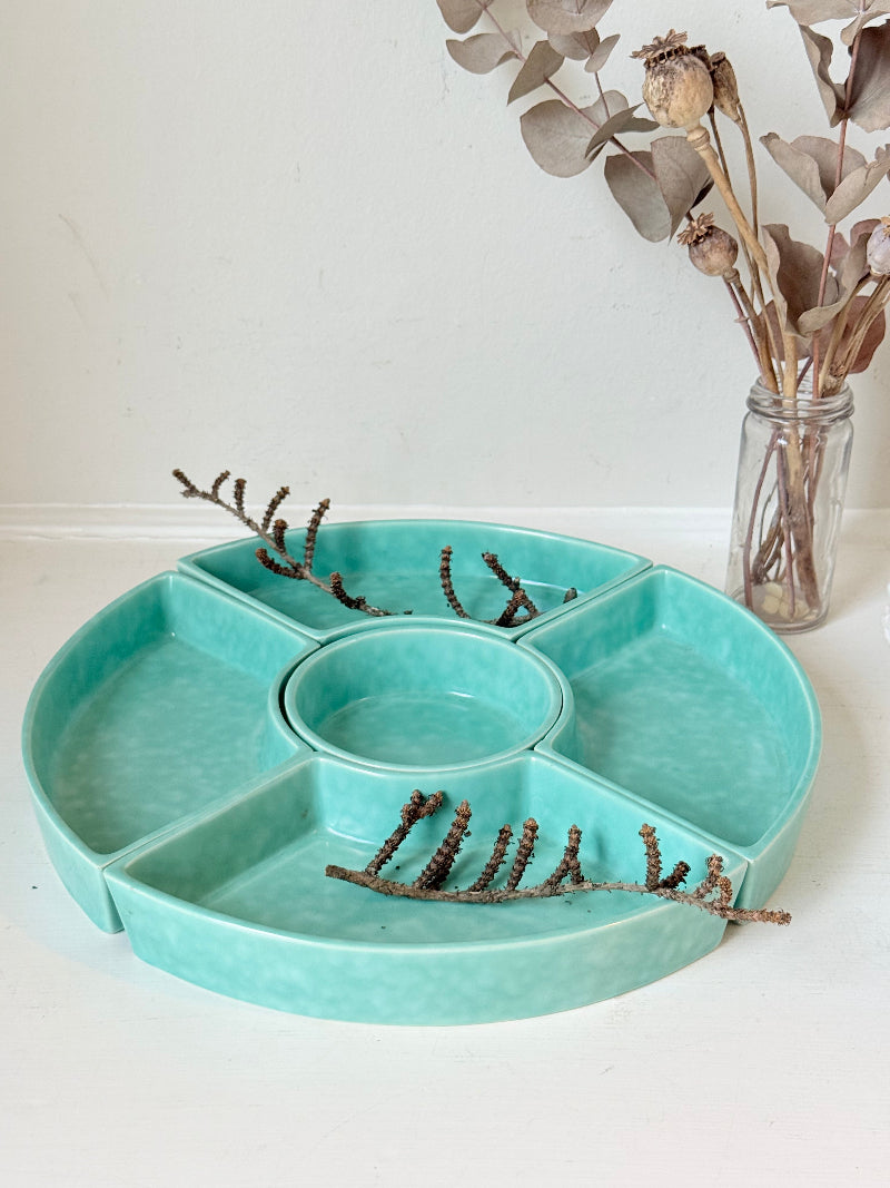 Poole Pottery turquoise hors d’oeuvre dishes set of five displayed on a white surface.