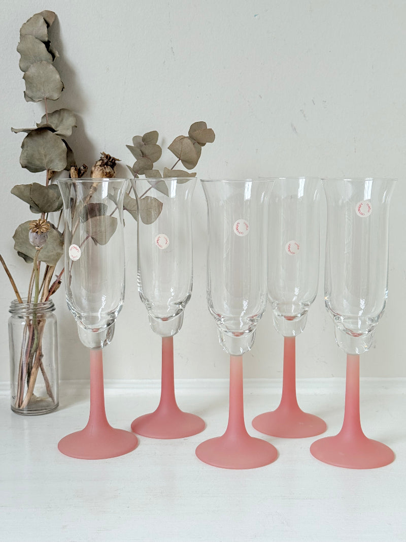 Set of five 1980s frosted pink tulip champagne flutes from the Candlelight range, photographed on a white surface
