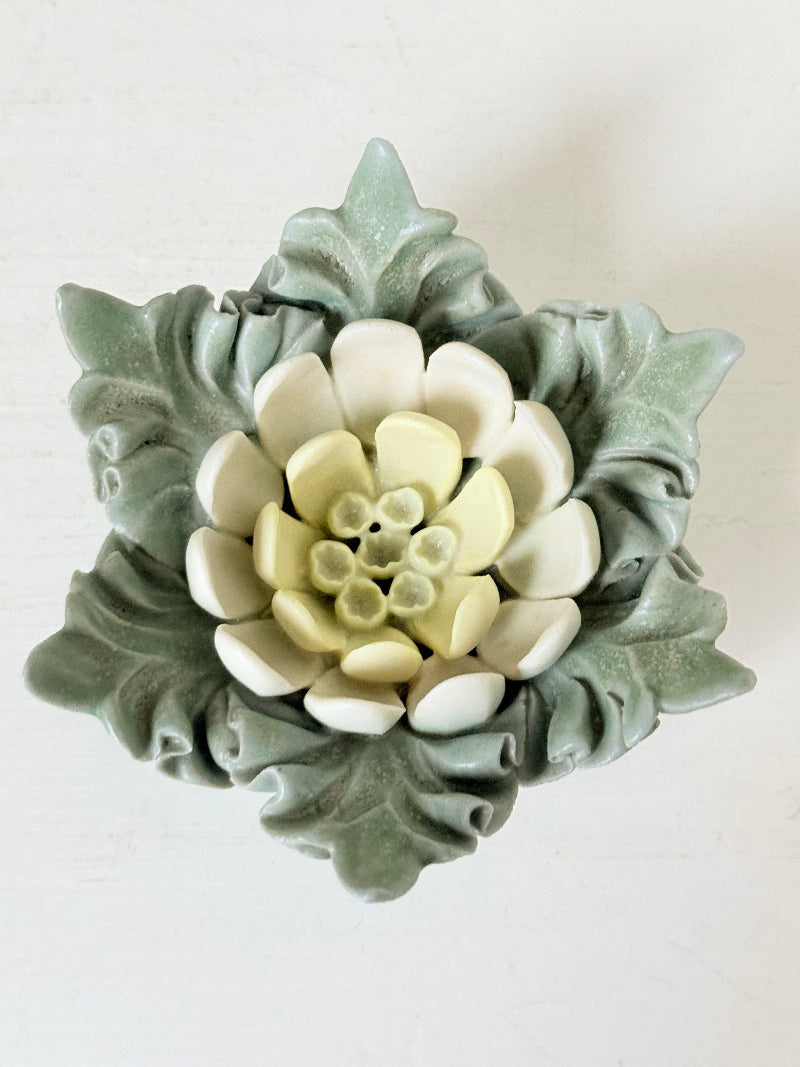 Vintage Chessell Pottery flower bowl in sage green and cream photographed on a white surface