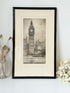 Vintage framed print of Big Ben in London, black frame, photographed on white surface with dried flowers