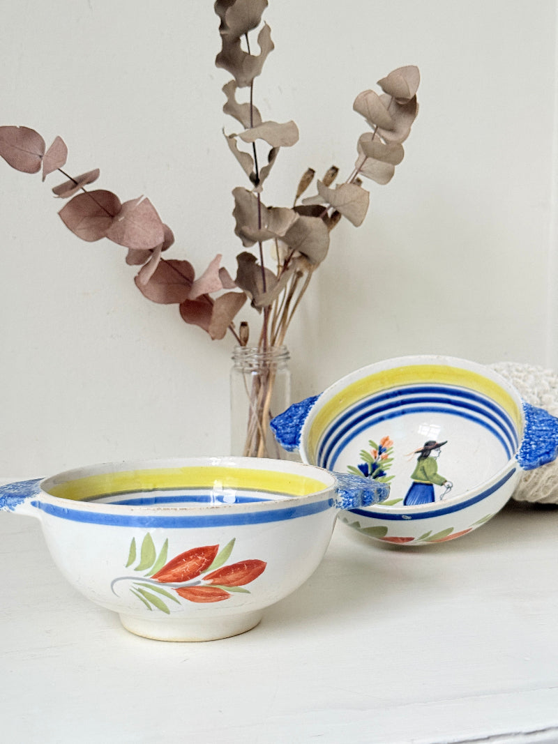 Pair of vintage French Quimper Breton figure bowls with blue handles, photographed on a white surface