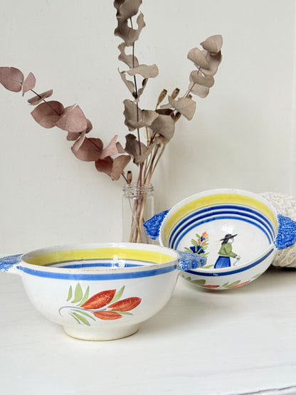 Pair of vintage French Quimper Breton figure bowls with blue handles, photographed on a white surface