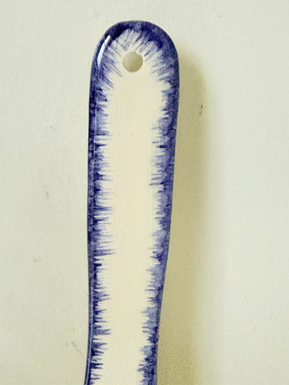 French Quimper faience handled wall dish with Petit Breton figure and blue rim, photographed on a white surface