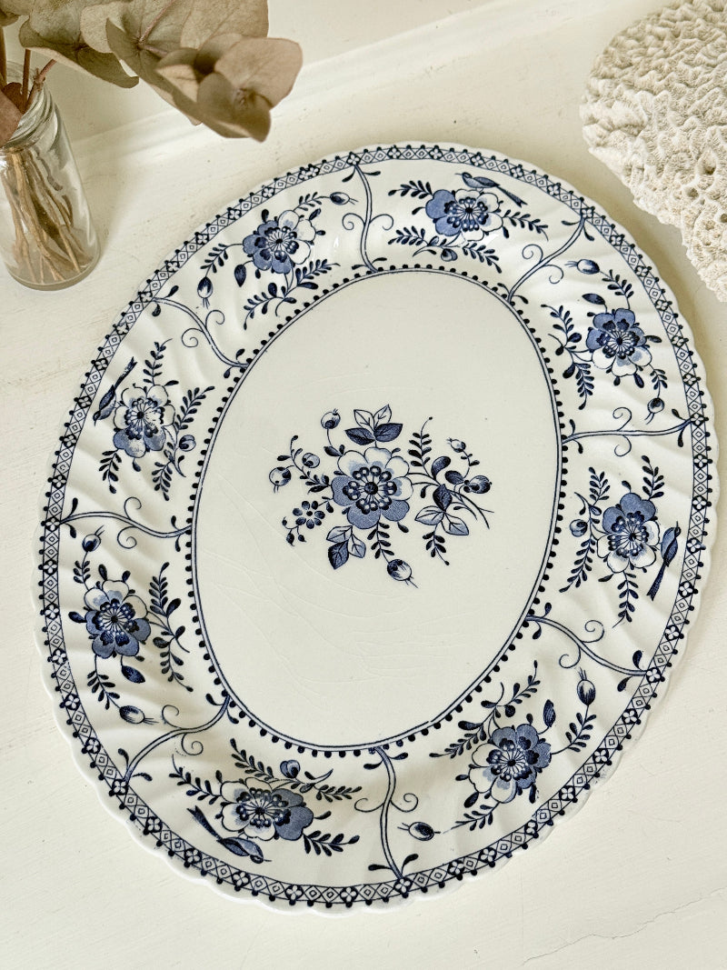 Vintage Johnson Brothers Indies blue and white oval serving platter photographed on a white surface