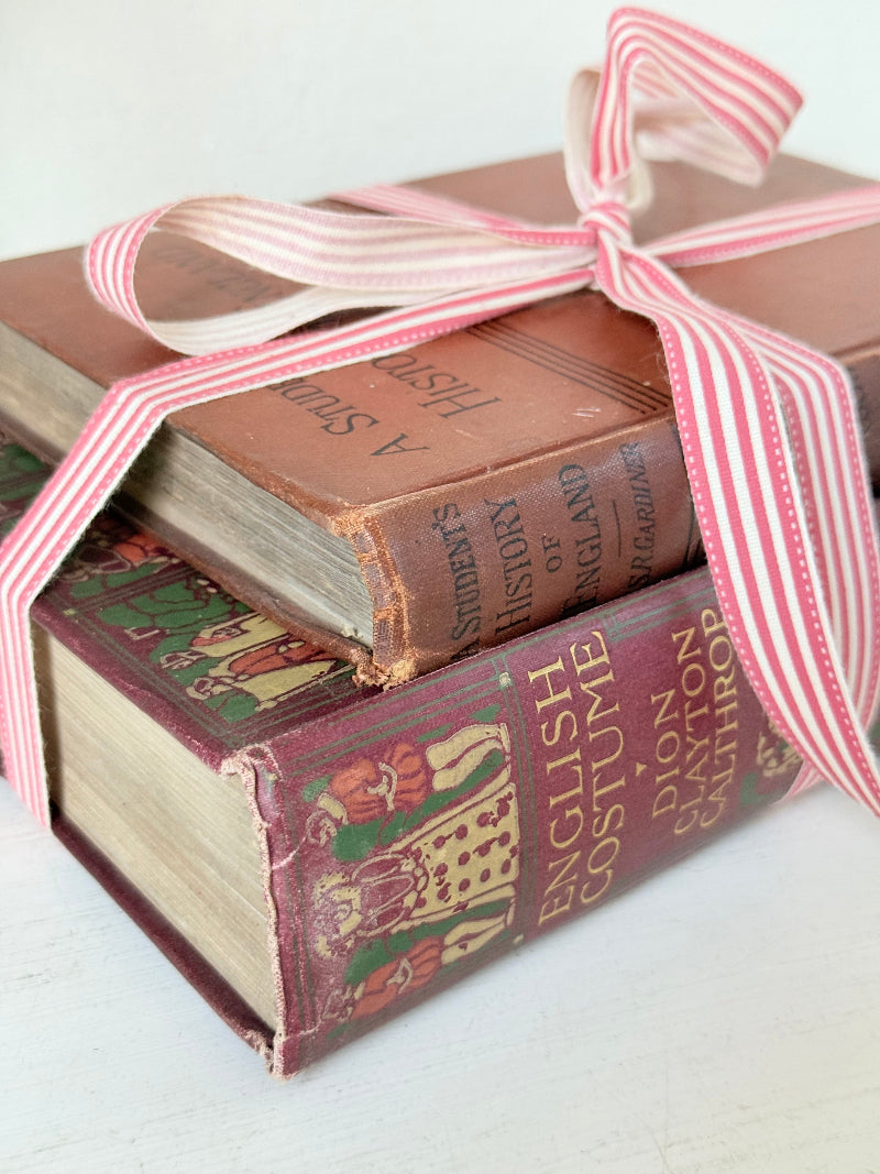 Vintage book bundle of English Costume and History of England with burgundy and brown hardback covers, photographed on a white surface