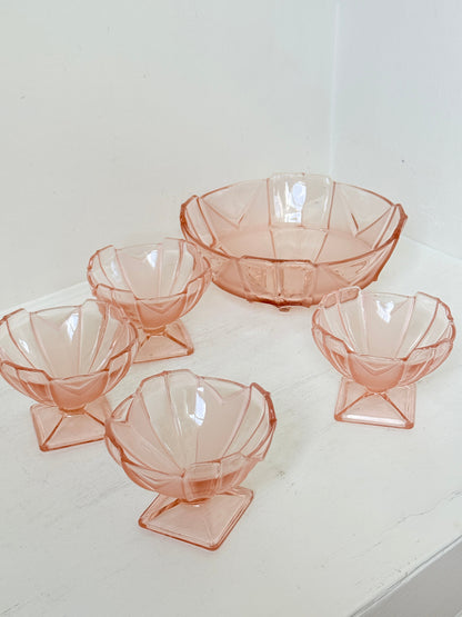 Art Deco pink pressed glass dessert service with scalloped serving bowl and four footed sundae dishes