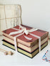 Large vintage decorative book bundle with burgundy cream and green hardback covers tied with ribbon for interior styling