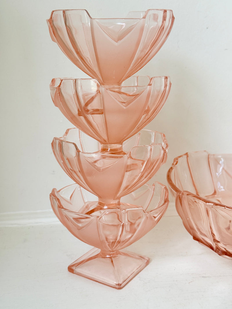 Art Deco pink pressed glass dessert service with scalloped serving bowl and four footed sundae dishes