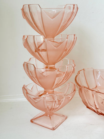 Art Deco pink pressed glass dessert service with scalloped serving bowl and four footed sundae dishes