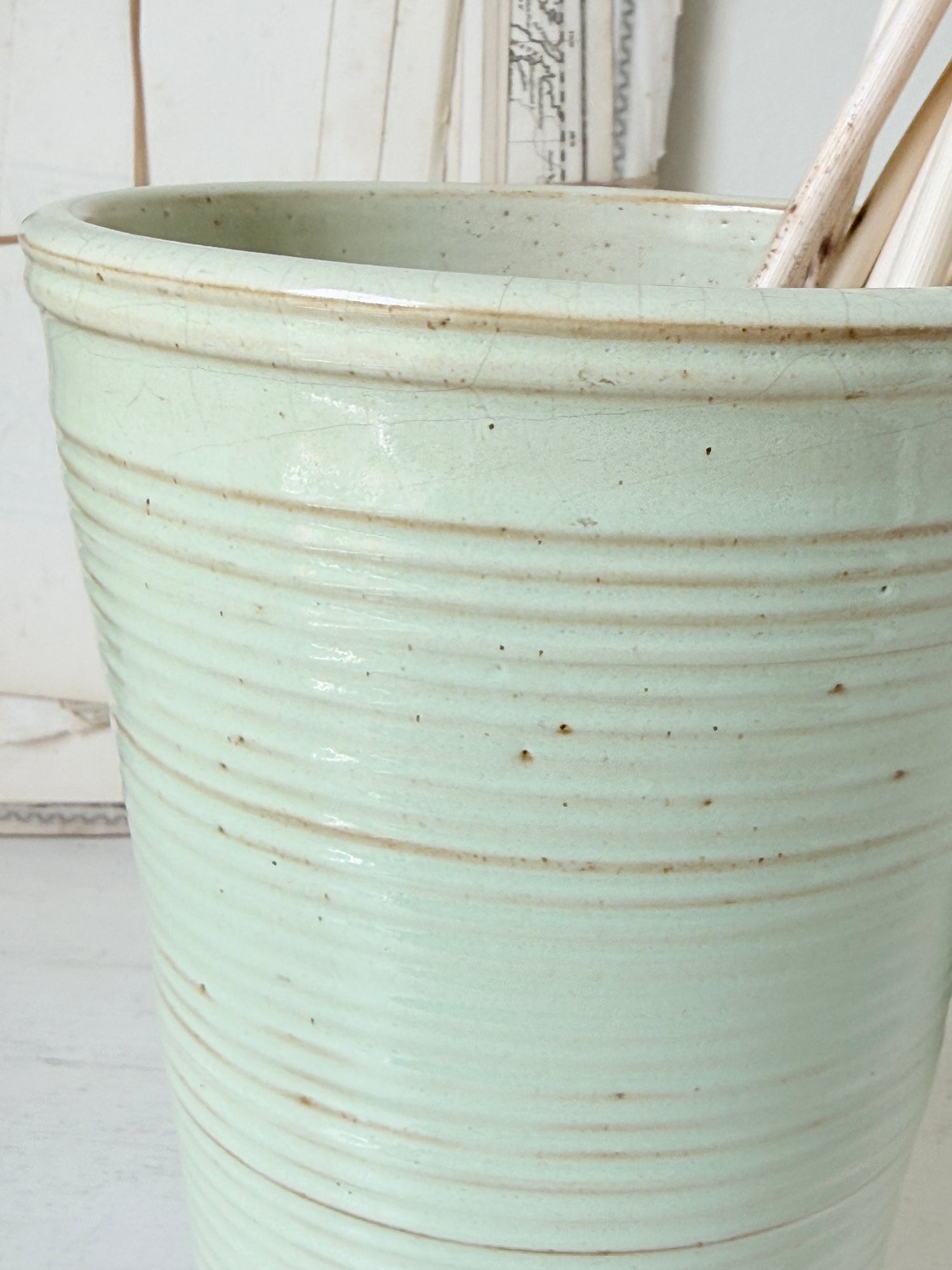 1960s Burton Ware ribbed stoneware pot in sage green, photographed on a white surface
