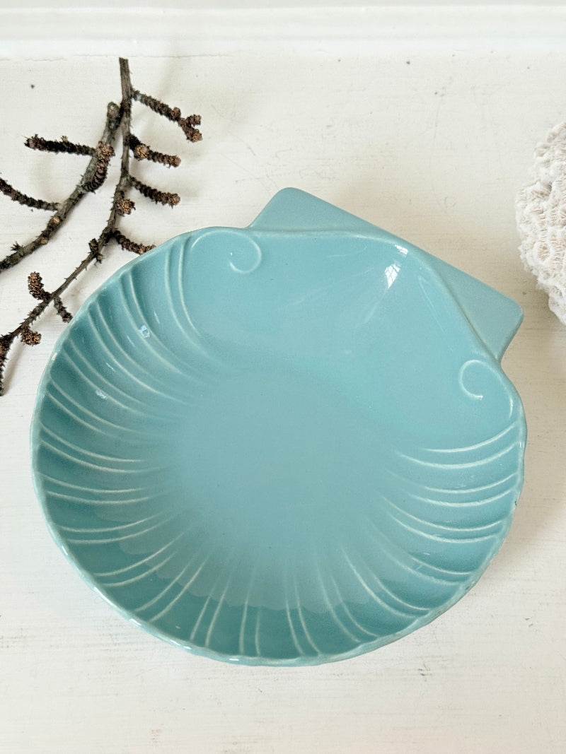 Poole Pottery scallop shell serving dish in sea blue glaze photographed on a white surface