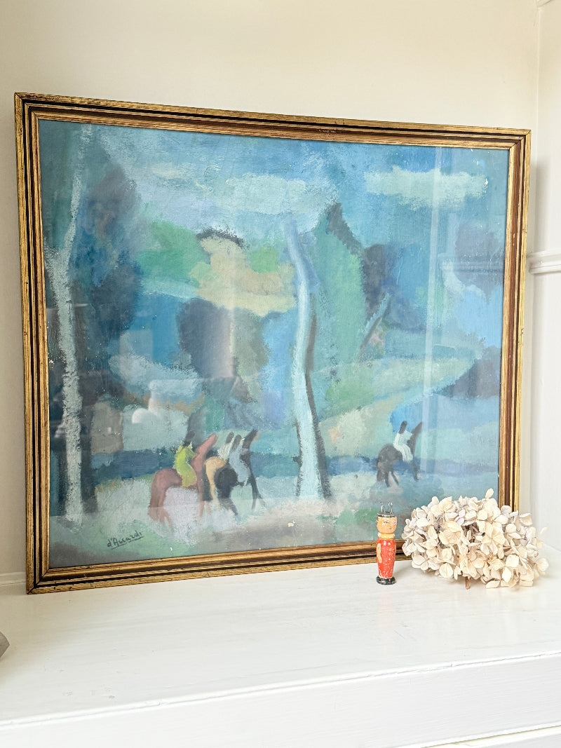 A framed impressionist landscape painting with blue, green, and gray tones, displayed on a white mantelpiece next to a small decorative object and a cluster of dried flowers.