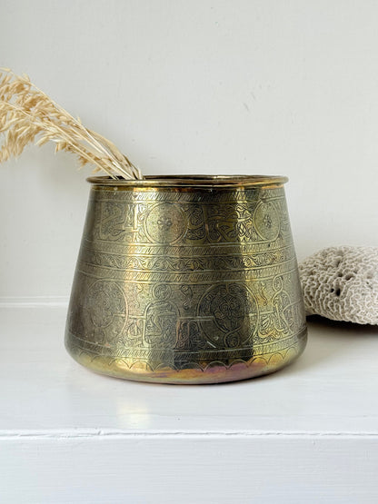 Large vintage brass pot with engraved decoration and aged patina, photographed on a white surface