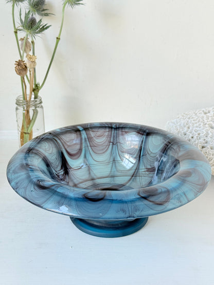 George Davidson blue cloud glass bowl with purple marbled swirls, photographed on a white surface