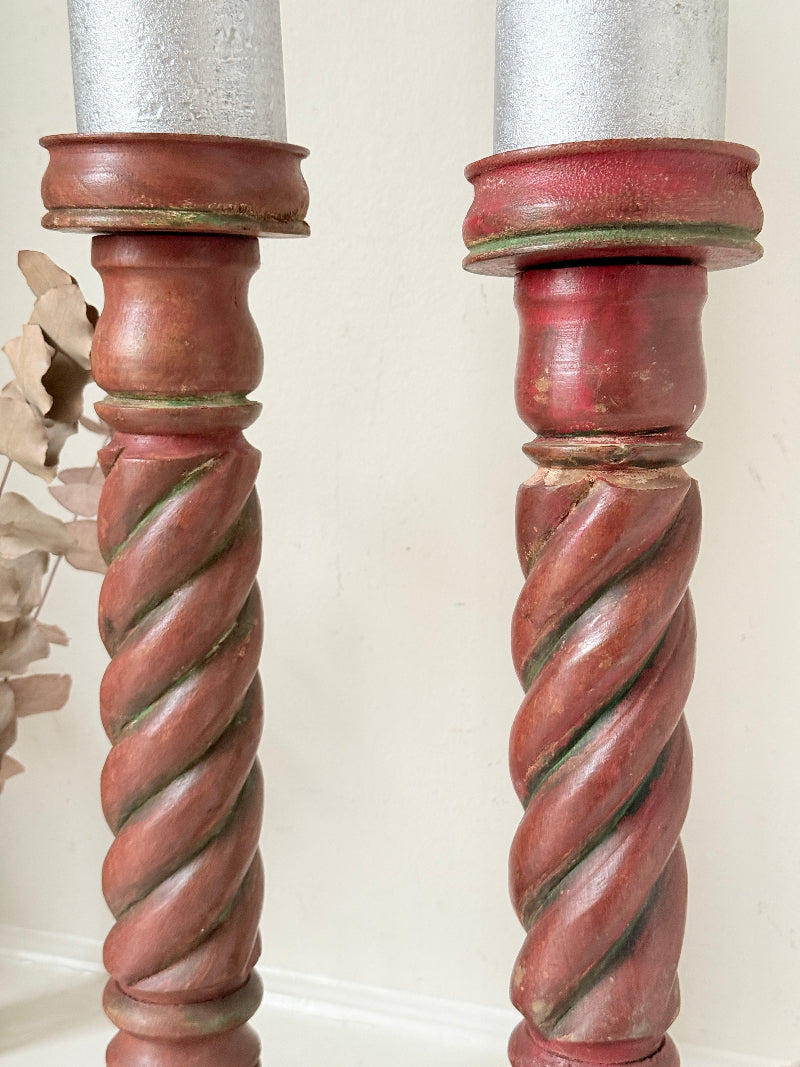 Vintage wooden barley twist candlesticks, a pair with painted finish, photographed on a white surface