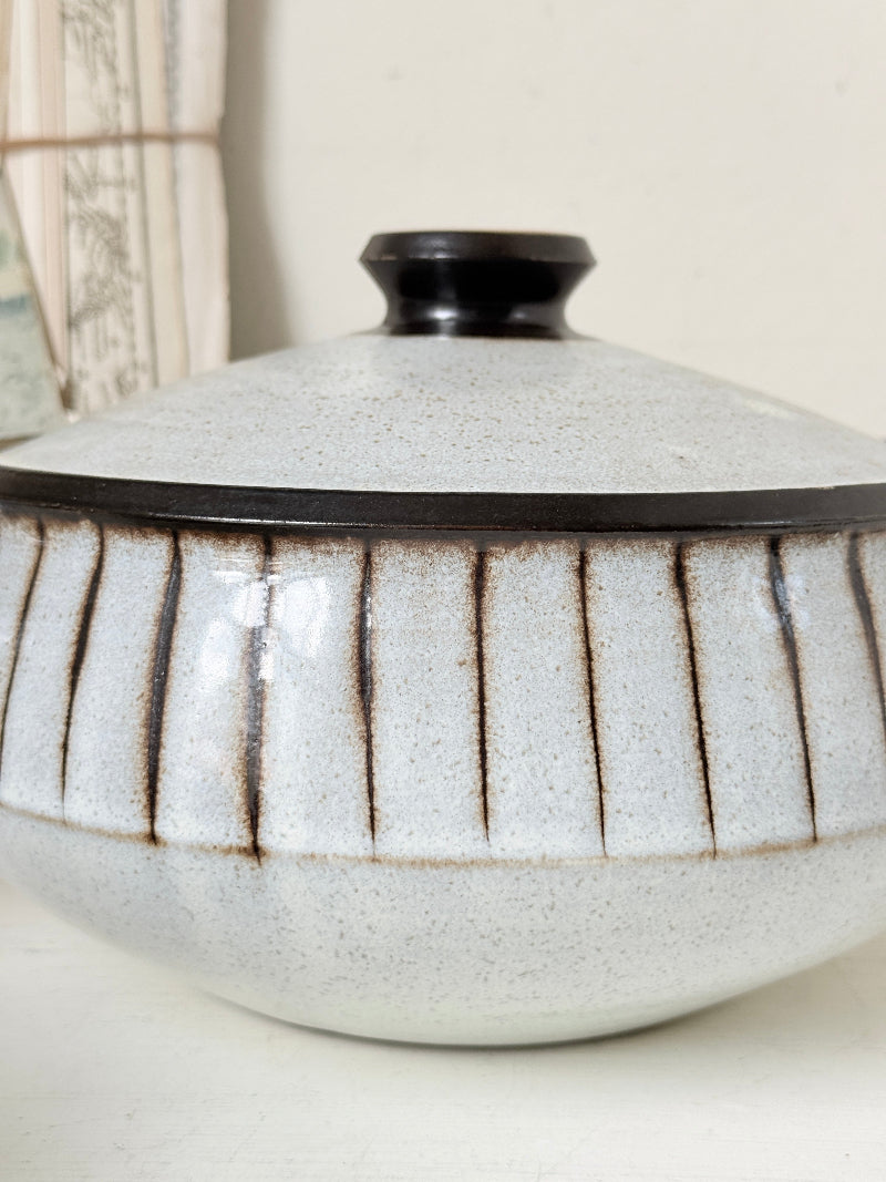 Denby Studio stoneware casserole and soup bowl set in grey and rust photographed on a white surface