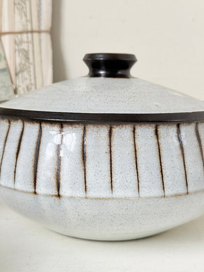 Denby Studio stoneware casserole and soup bowl set in grey and rust photographed on a white surface