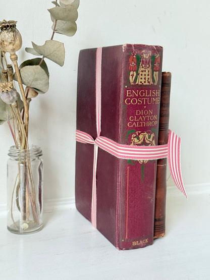 Vintage book bundle of English Costume and History of England with burgundy and brown hardback covers, photographed on a white surface