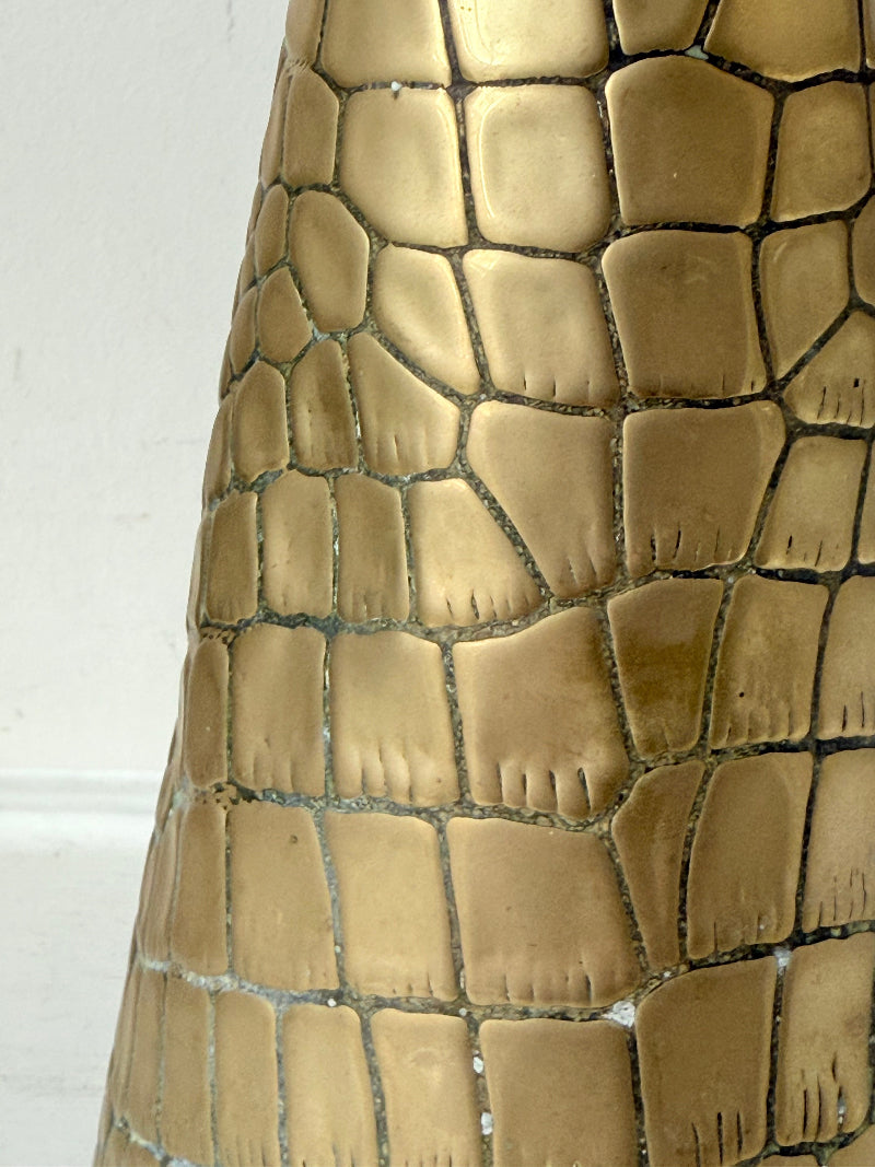 Vintage brass jug with alligator patterned surface, photographed against a white background.