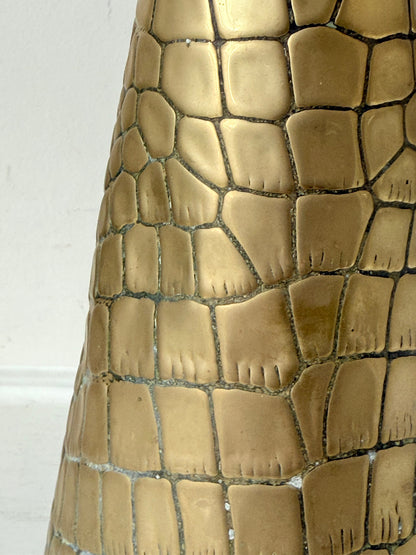 Vintage brass jug with alligator patterned surface, photographed against a white background.