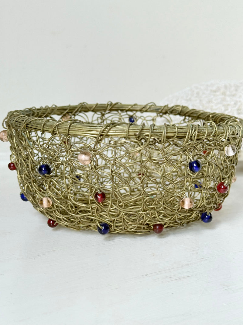 Vintage brass wire basket with coloured glass beads, photographed from multiple angles on a white surface