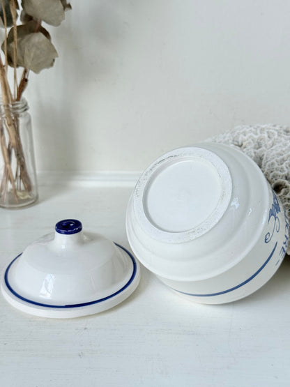 Vintage French blue and white studio pottery sugar bowl with lid, photographed on a white surface.