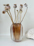 Vintage ribbed amber brown glass vase photographed on a white surface