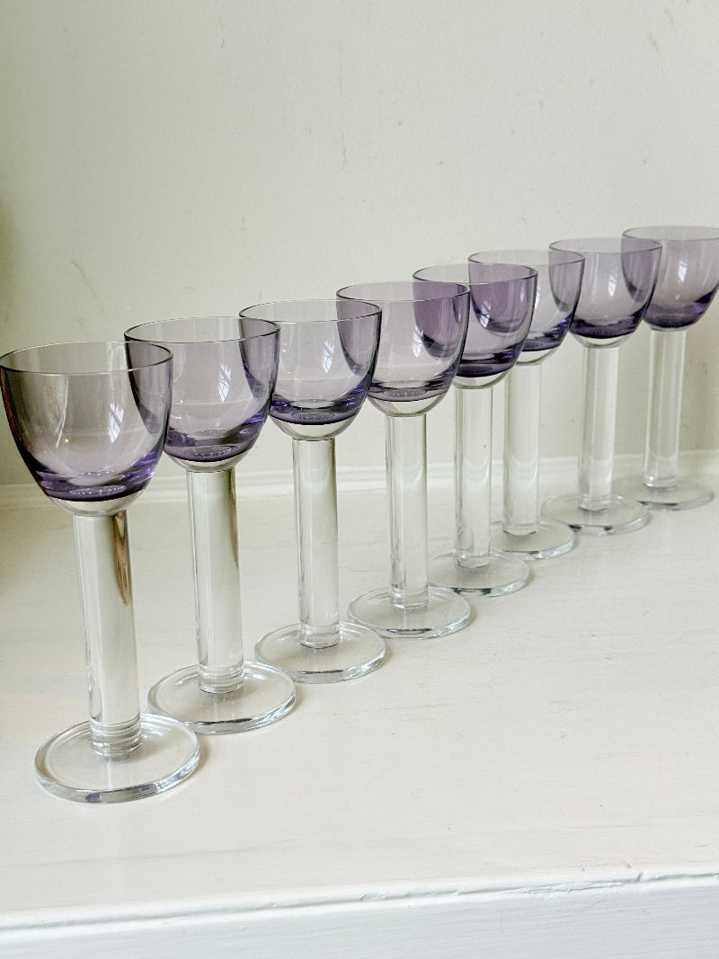 Set of 8 vintage lilac tinted liqueur glasses on a white surface