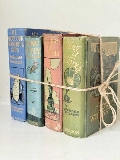 Vintage decorative book bundle in green, blue, and coral with printed lettering, tied with twine, photographed on a white surface