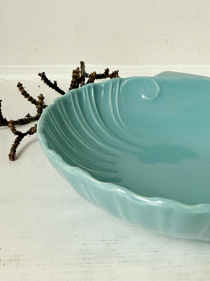 Poole Pottery scallop shell serving dish in sea blue glaze photographed on a white surface