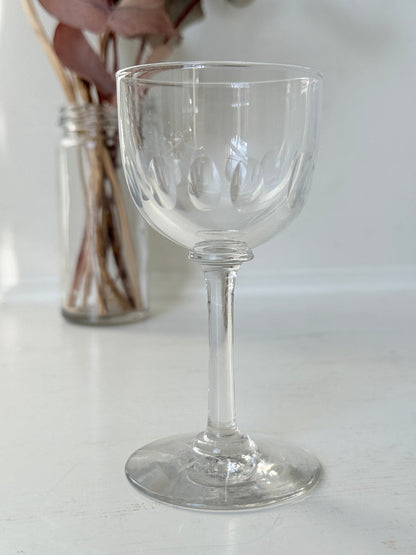 Set of 5 vintage clear glass liqueur glasses with small stems photographed on a white surface