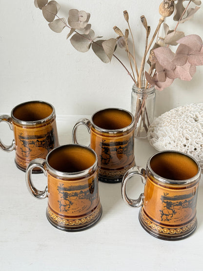 Set of 4 Ridgways stoneware tankard mugs photographed on a white surface in amber brown treacle glaze with black Coaching Days and Coaching Ways transfer scenes