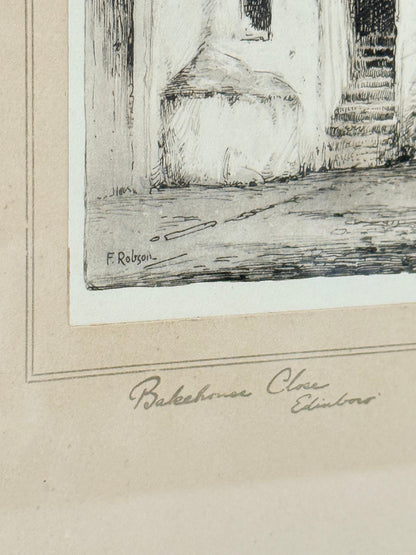 framed black and white print of edinburgh old town architecture photographed on white surface
