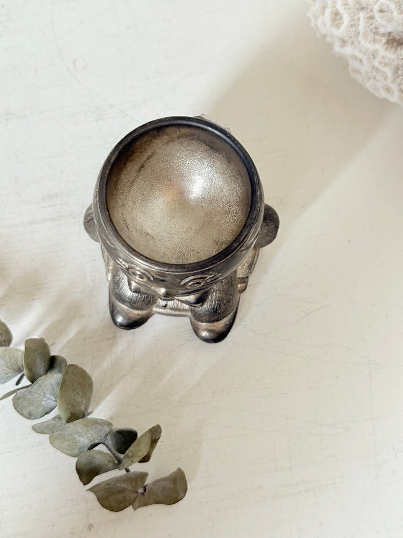 Vintage Humpty Dumpty silver plate egg cup, photographed on a white surface