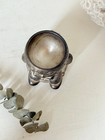 Vintage Humpty Dumpty silver plate egg cup, photographed on a white surface