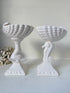Two white ceramic decorative bowls with seahorse-shaped pedestals, displayed on a white surface against a light neutral background.