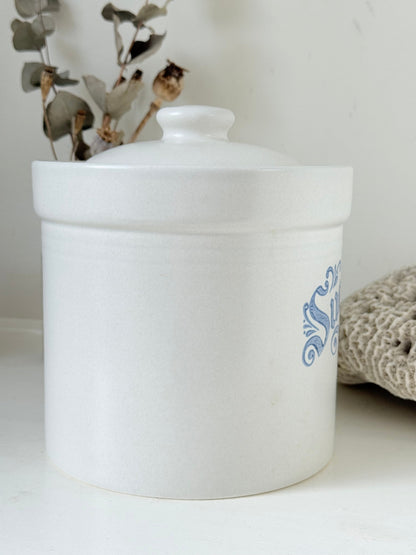 Pfaltzgraff Yorktowne stoneware sugar jar with blue floral motif and lid, photographed on a white surface