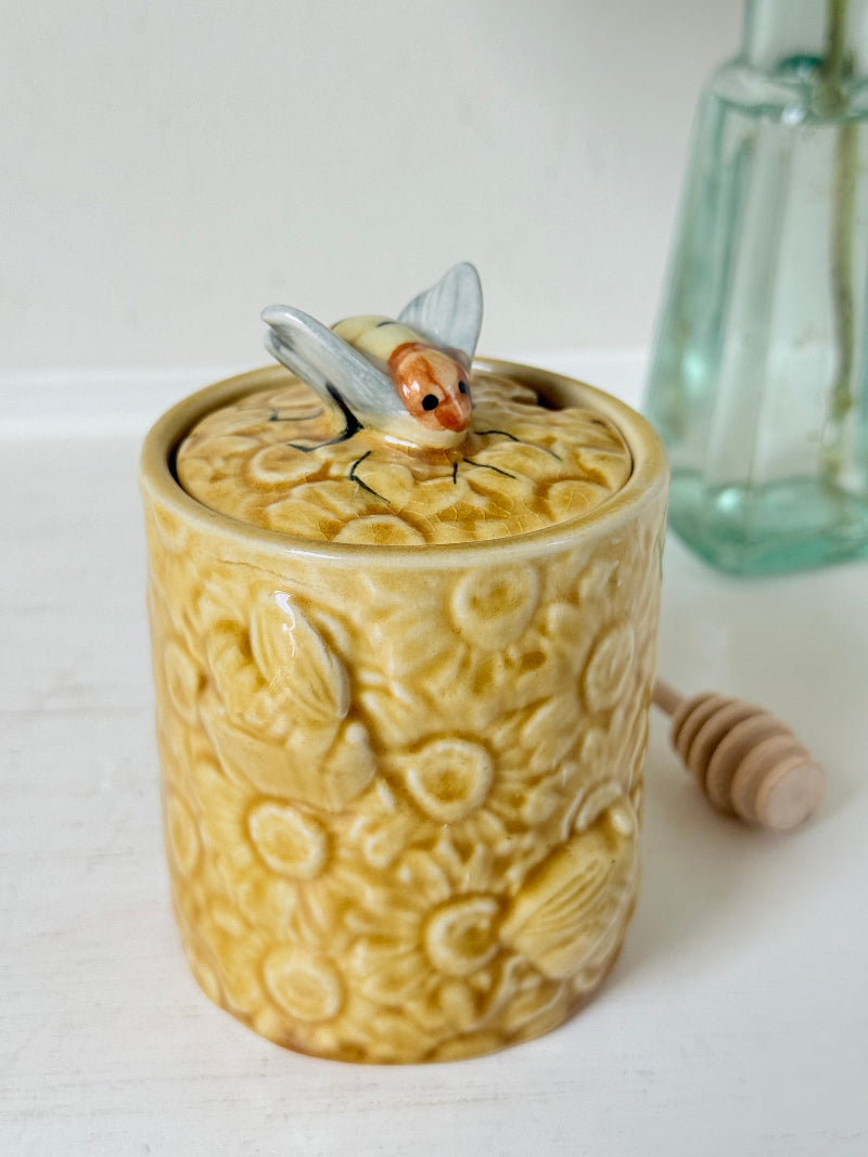 Secla pottery honey jar with lid, bee motif, and wooden honey spoon, made in Portugal, photographed on a white surface