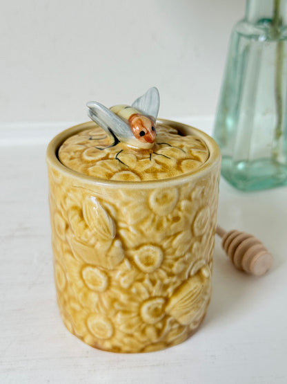 Secla pottery honey jar with lid, bee motif, and wooden honey spoon, made in Portugal, photographed on a white surface