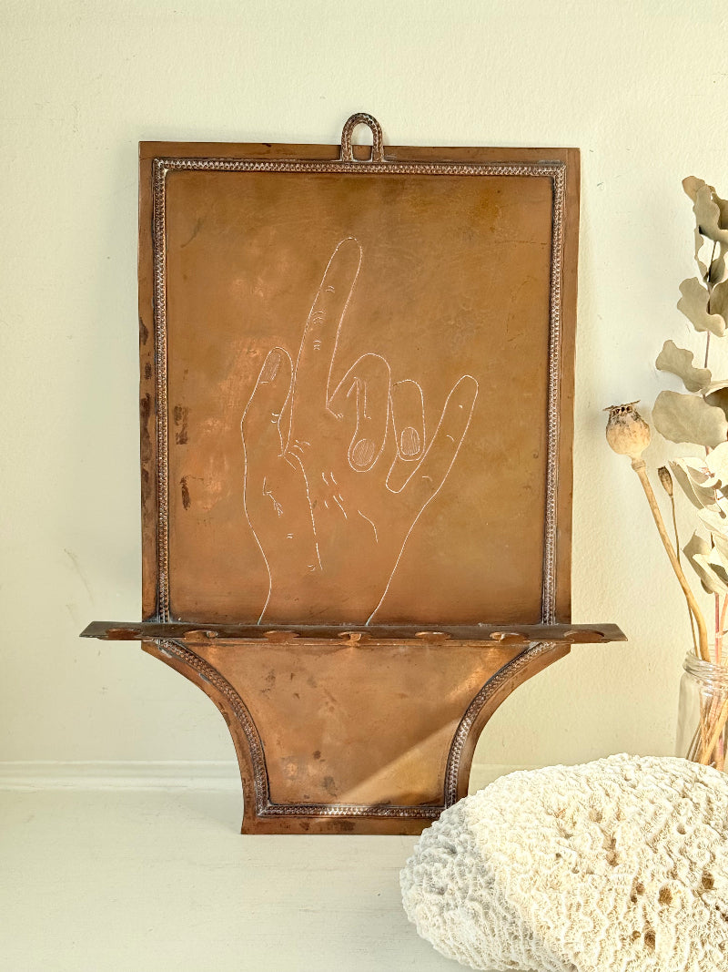 Vintage hanging copper pipe stand with hand etched design, ideal for holding utensils, tools or dog leads, photographed on a white surface beside dried stems.