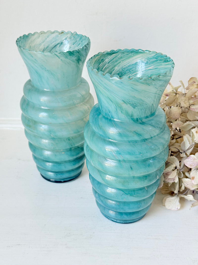 Pair of vintage aqua blue glass vases with beehive pattern and scalloped edges, photographed on a white surface