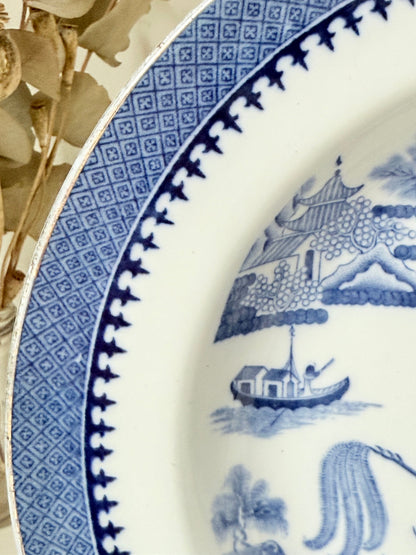 Minton Blue Willow serving dish dated 1928 with blue transfer pattern shown on a white surface.