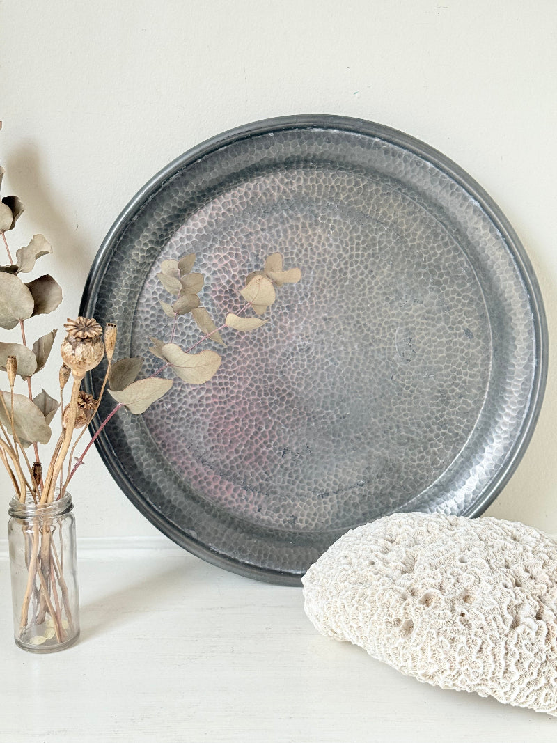 Vintage Harrods pewter drinks tray with hammered surface photographed on a white background.