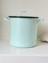 Vintage pale blue enamel bread bin with lid and handles, photographed on a white surface