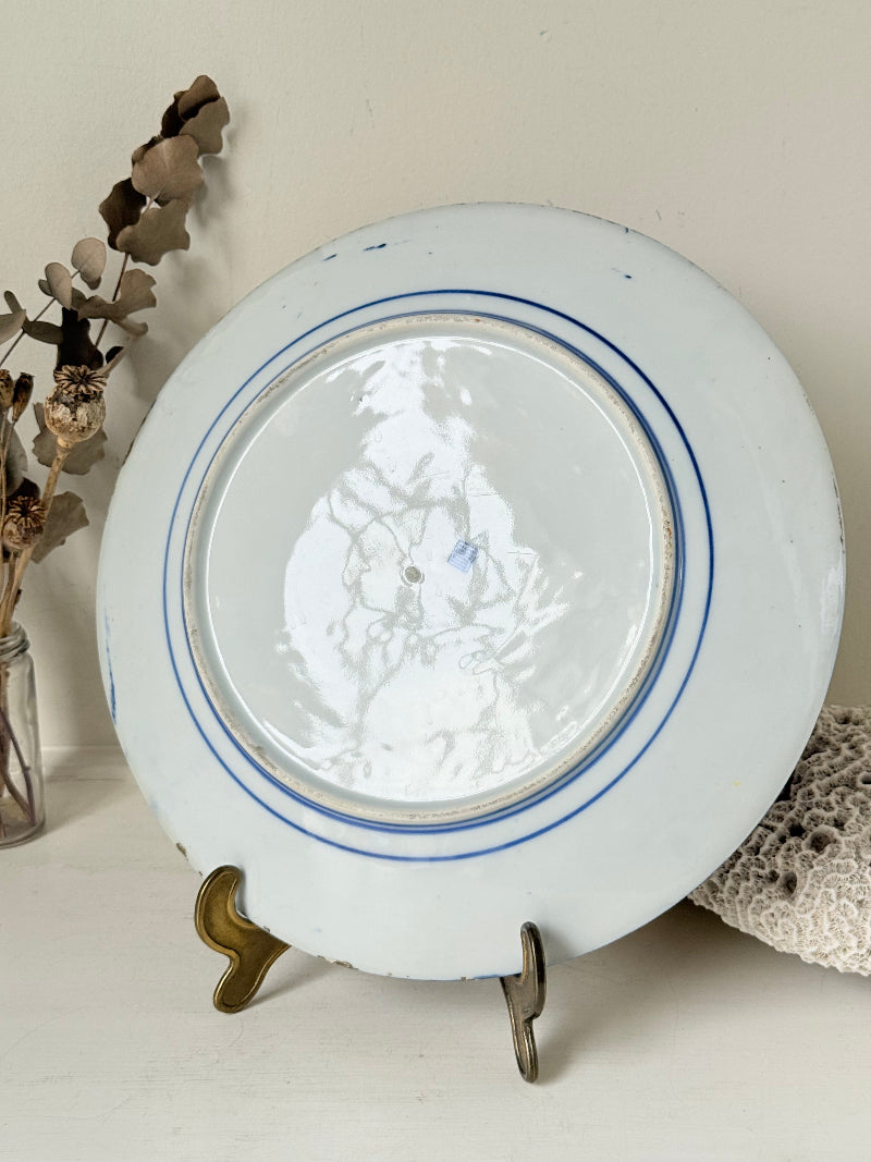 Antique Japanese Aoki Brothers platter with colourful Imari style floral pattern photographed on a white surface