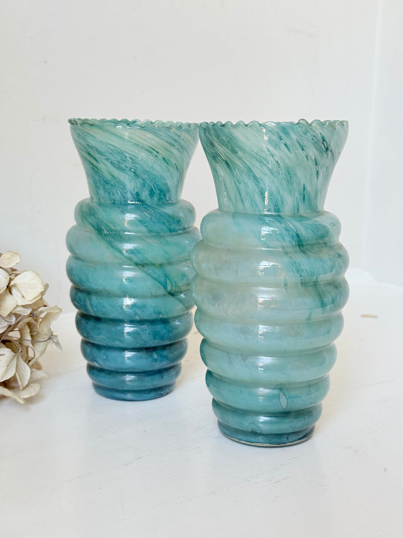 Pair of vintage aqua blue glass vases with beehive pattern and scalloped edges, photographed on a white surface
