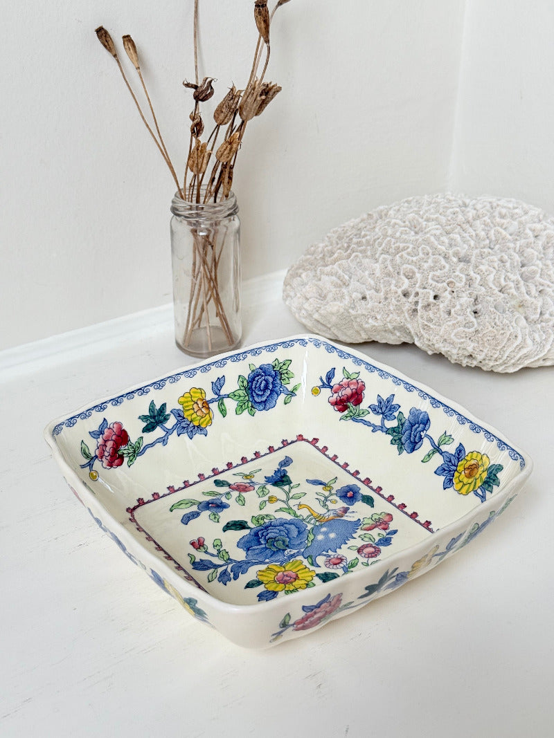 Vintage Mason’s ironstone serving dish with square form and spring floral pattern in blue, pink, yellow, and green, photographed on a white surface