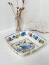 Vintage Mason’s ironstone serving dish with square form and spring floral pattern in blue, pink, yellow, and green, photographed on a white surface
